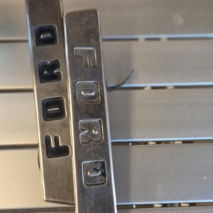 Pair of vintage Ford chrome bonnet badges.